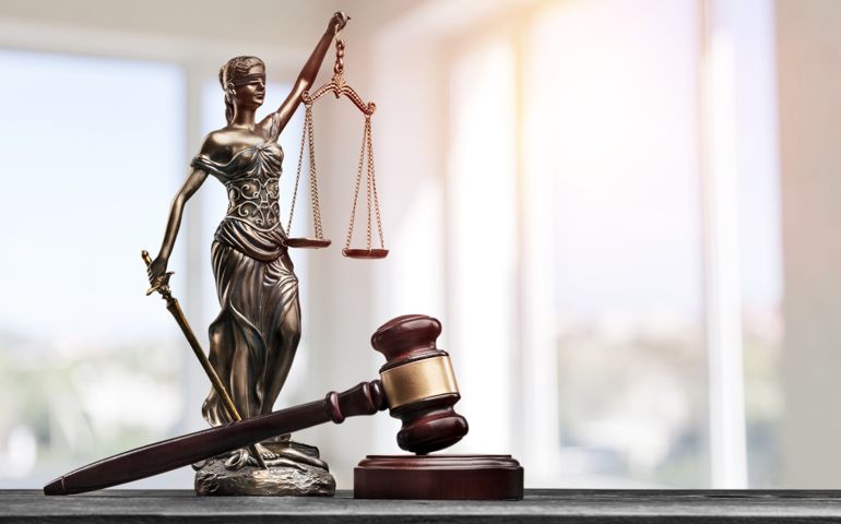 figurine of Justice with balanced scales and a gavel