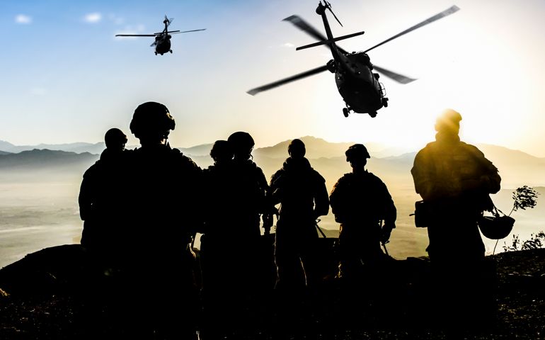 silhouettes of soldiers and helicoptors
