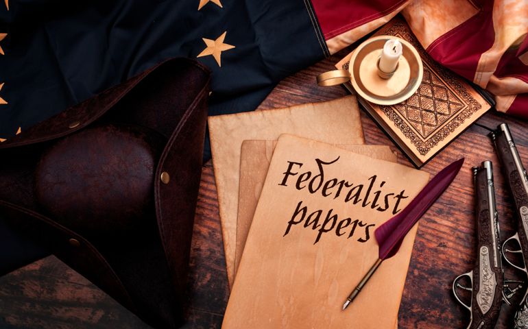 Federalist papers and the birth of the United States of America concept with tricorn hat, candle, feather quill