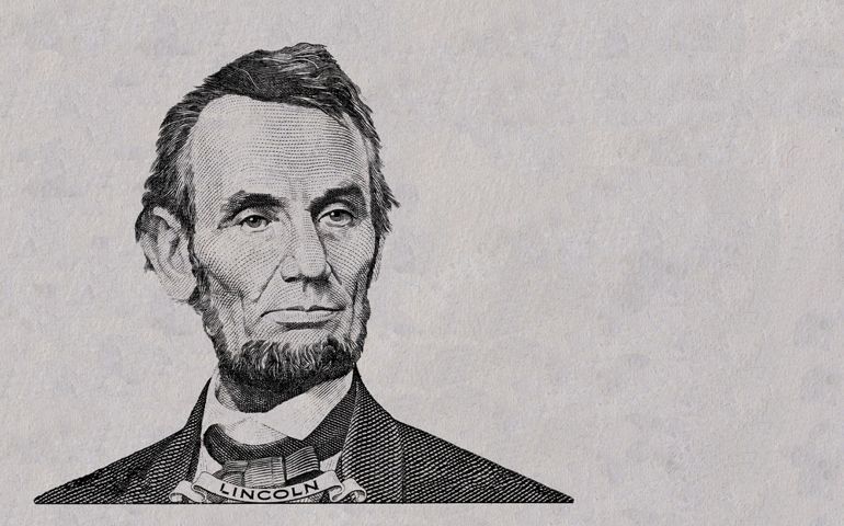 Abraham Lincoln cut on new 5 dollar banknote isolated on white background
