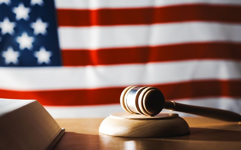 U.S. Supreme Court with gavel on a book and U.S. flag