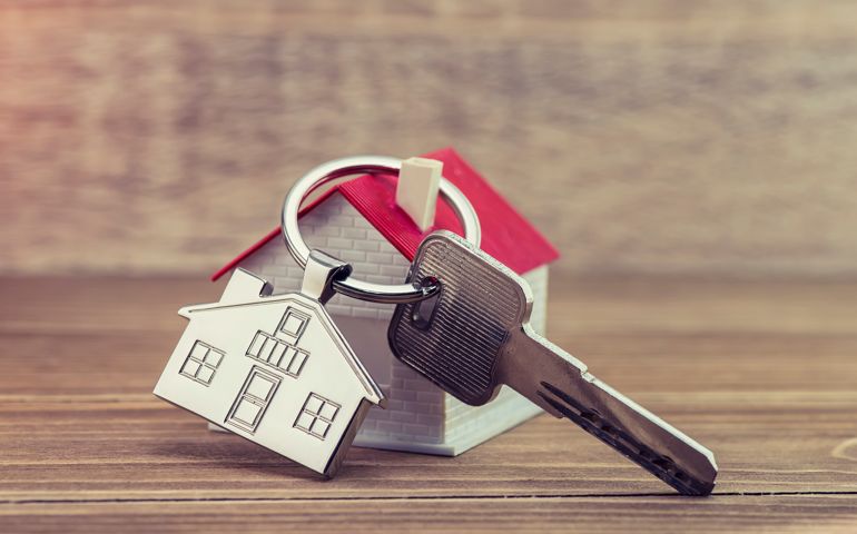 House Key And Key chain On Wooden Table