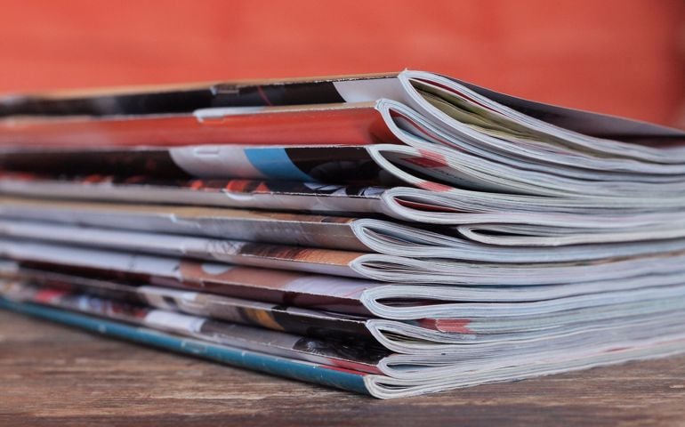 Old magazines on wooden table