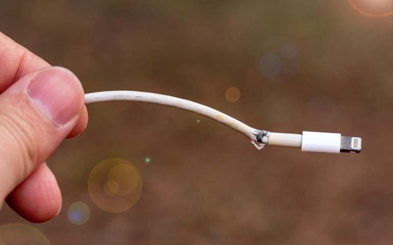 Close-up of broken smartphone's charger cable