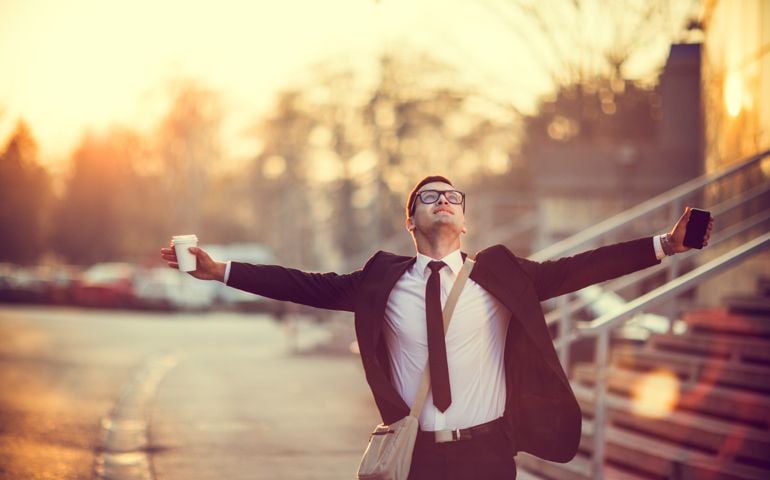 Businessman smiling with arms outstretched