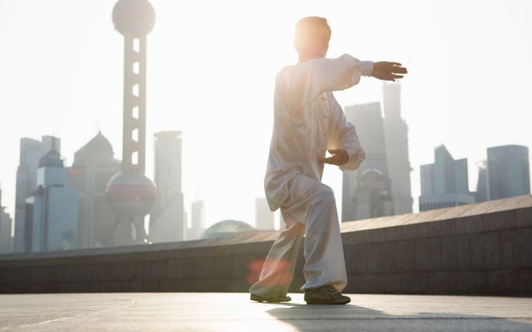 Chinese man practicing Tai Chi in the morning