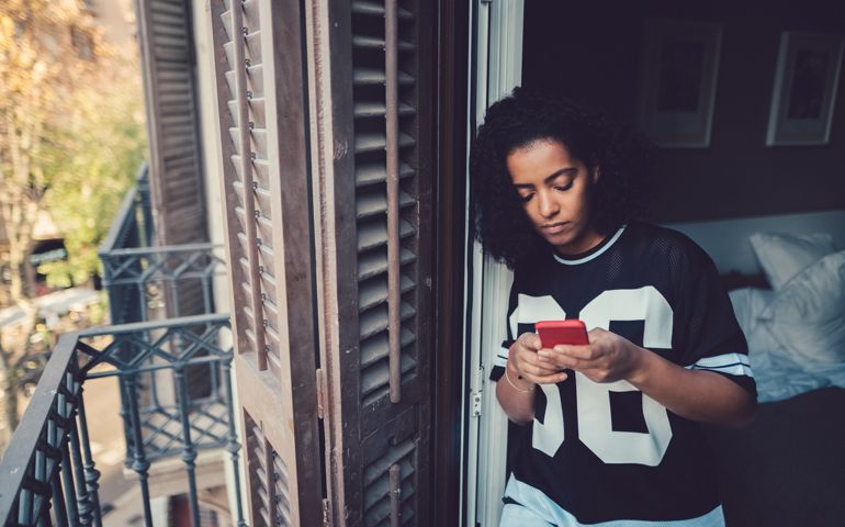 Depressed woman at home text messaging