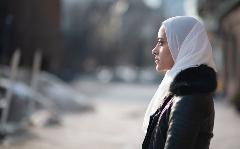 sad-looking woman standing alone