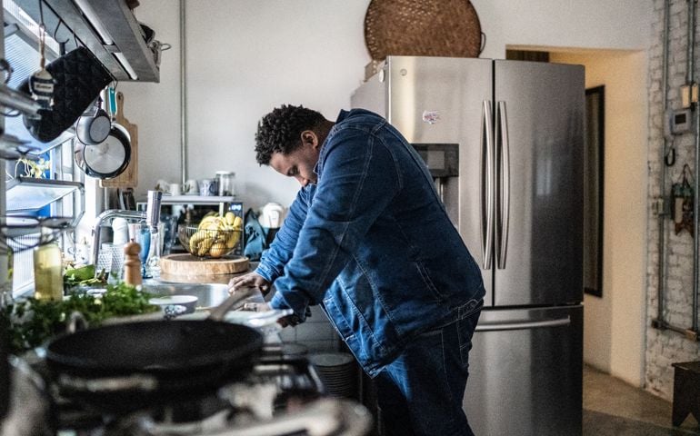 Man in the kitchen overwhelmed with sadness suddenly