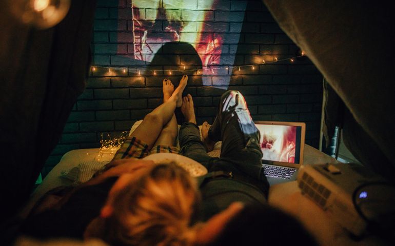 Romantic couple watching movies in home theater