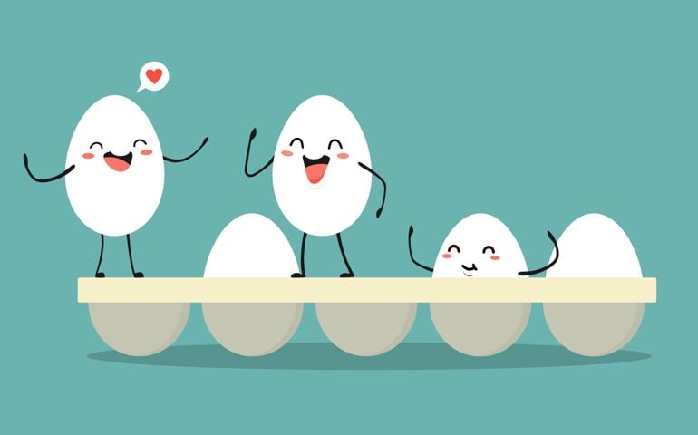 Cheerful eggs in a tray. Vector illustration in cartoon style.