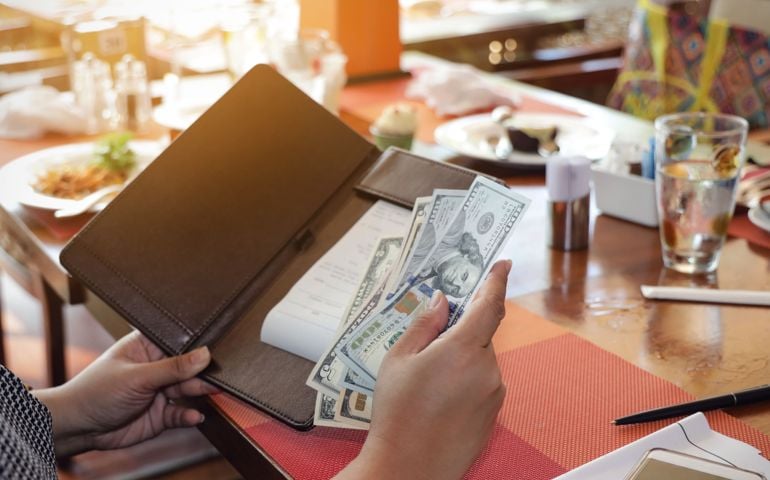 Close up of woman hand with a Bill With American Dollars which people, payment and finances concept