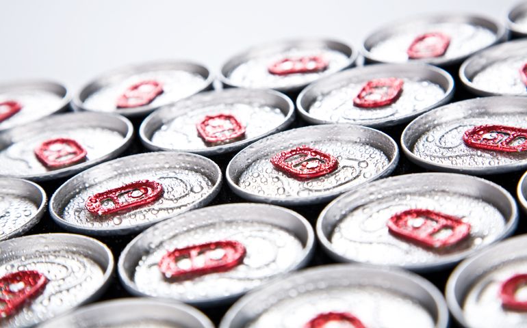 Soda cans lined up with condensation on top