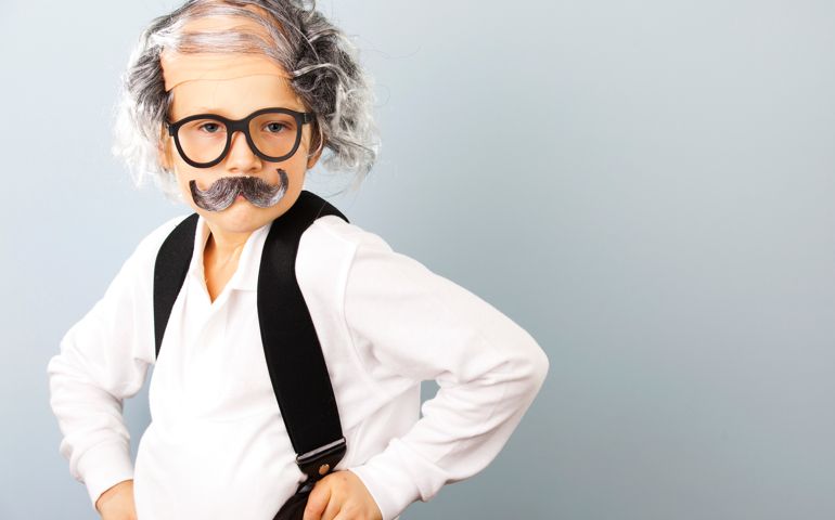Little boy dressed as an old man.