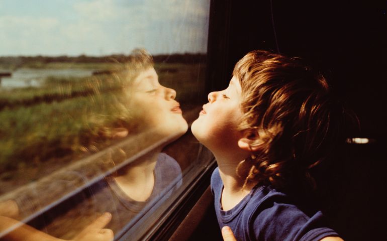 Child and Reflection in Window