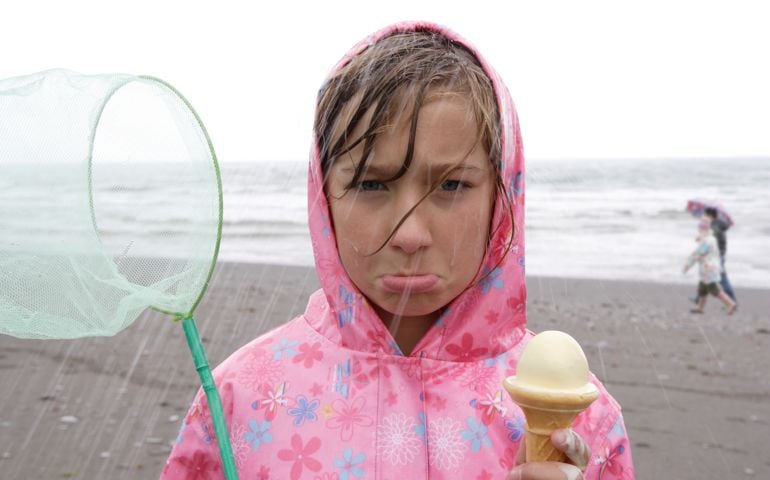 girl on beach in rain