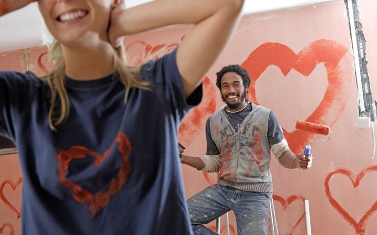 wall painted with hearts, woman walking away