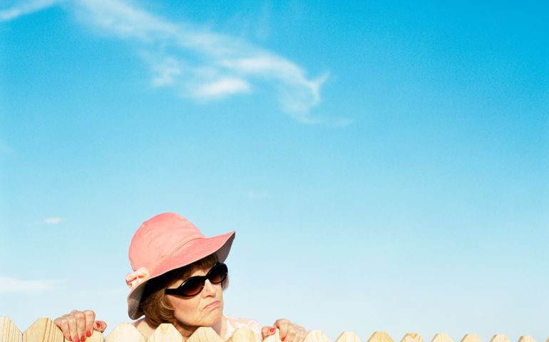 Mature woman looking over fence