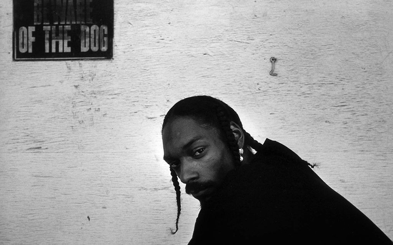 LOS ANGELES - 1998: Rapper Snoop Dogg poses for a portrait session underneath a sign that warns "Beward Of The Dog" in an alley oustide of Encore Studios in 1998 in Burbank, California.