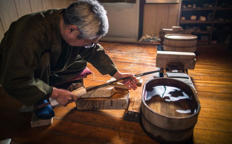 A craftsmen sharpens a traditional Japanese sword