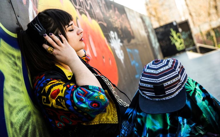 Hip hop woman in vintage 90s clothing listening to music