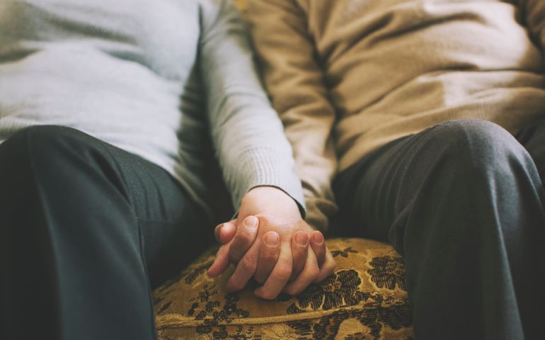 Senior couple holding hands