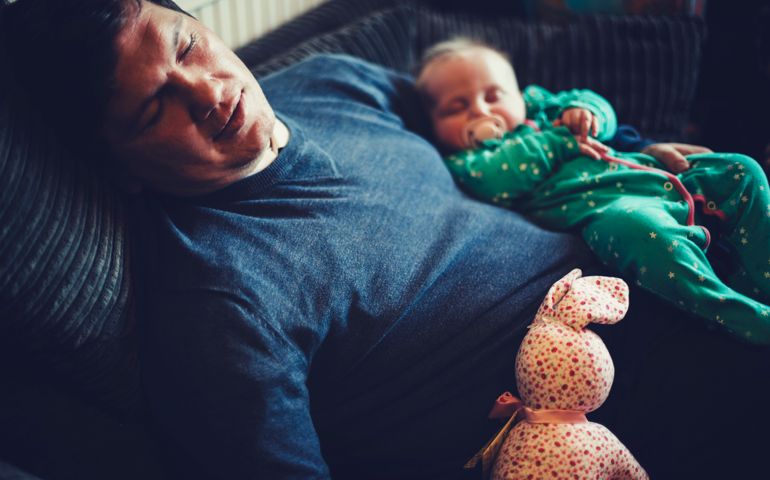 Father and baby girl sleeping