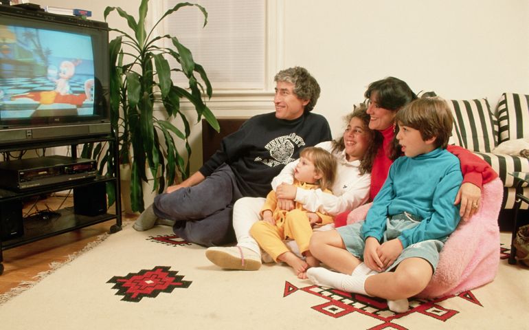 A family watches a video on their television
