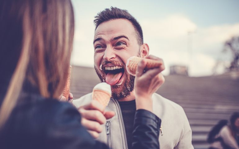 Beautiful Couple Eating Ice Cream in Autumn