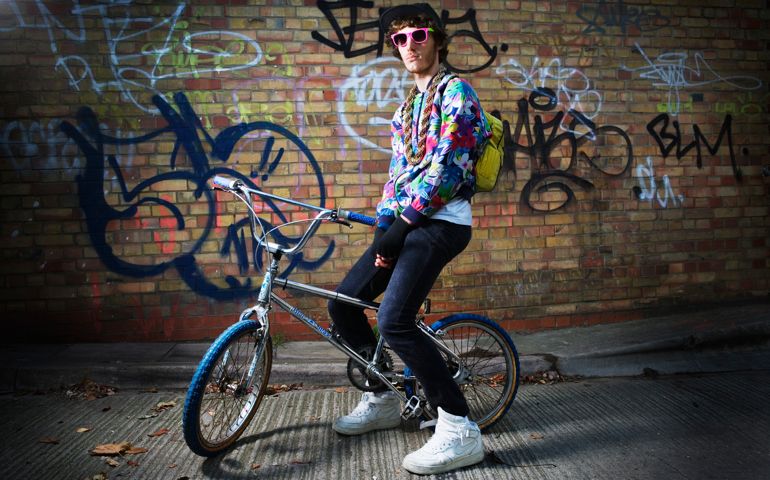 Young man sitting on bike.