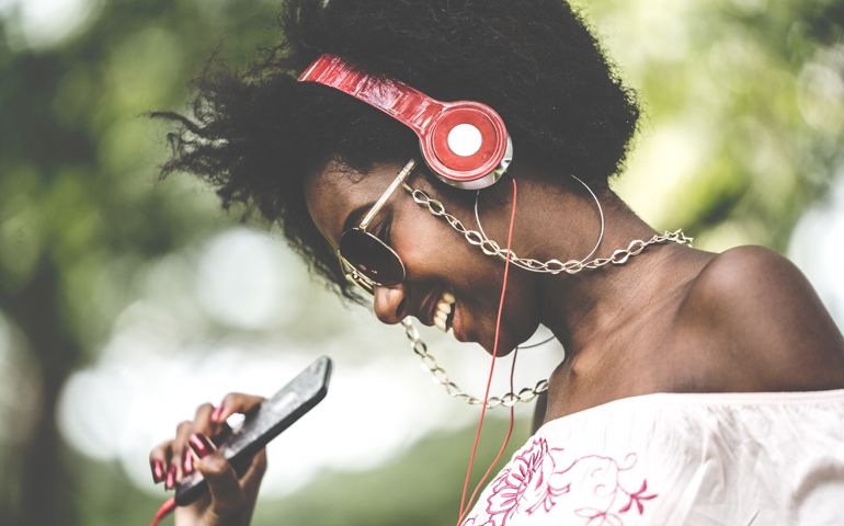 Woman Listening Music at Park