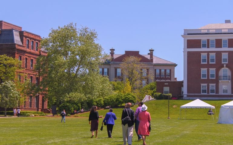 ‎April ‎23 ‎2015 Middletown Connecticut An ethnic family walks across Wesleyan University campus with tents up for graduation
