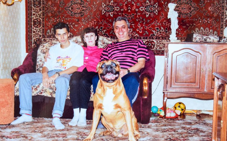 Vintage photo of family portrait with boxer dog in living room in Leningrad, USSR
