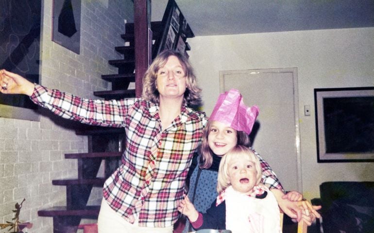 Mother with her two children celebrate Christmas at home.