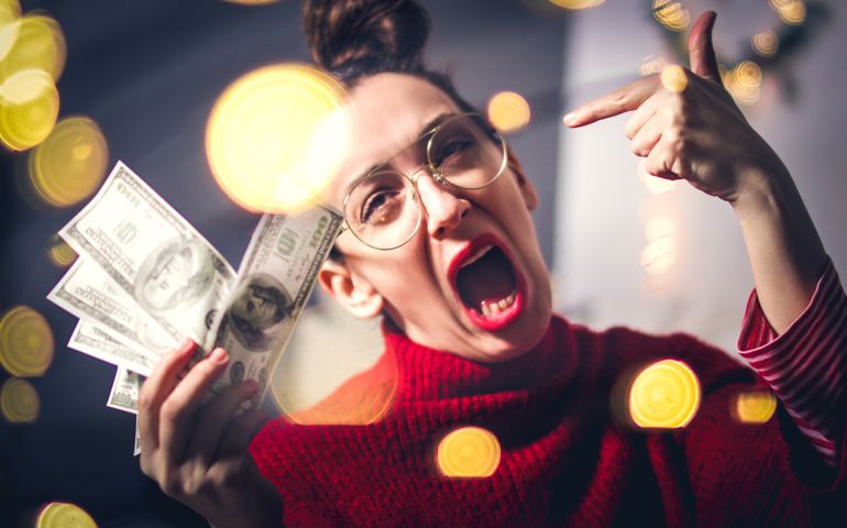 Excited hipster woman and flying dollar bills