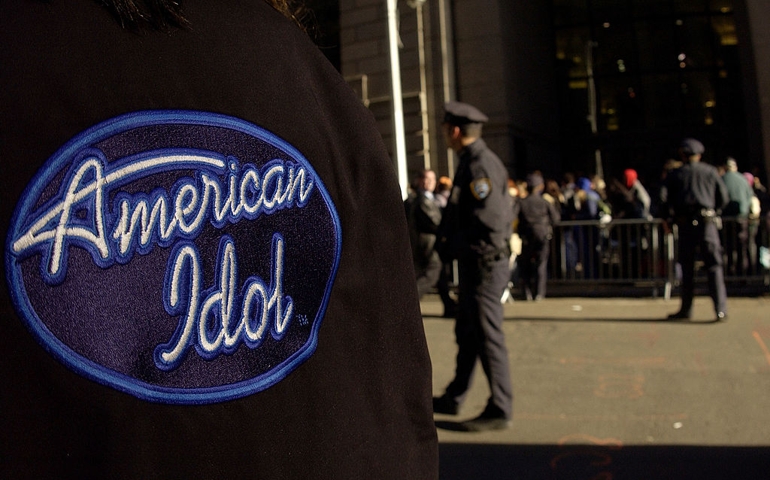 NEW YORK - OCTOBER 24: NYPD officers stand guard as hundreds wait outside the Regent Hotel, Wall Street, to audition for "American Idol" October 24, 2002 in New York City.