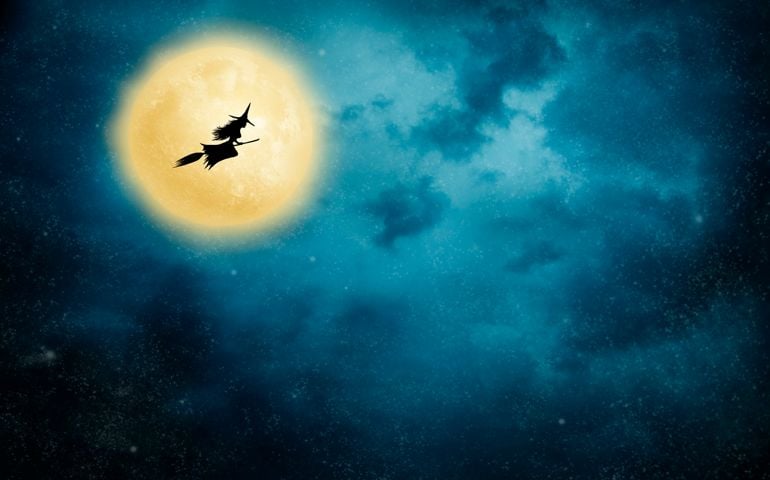 Night flight. Witch riding a broom.