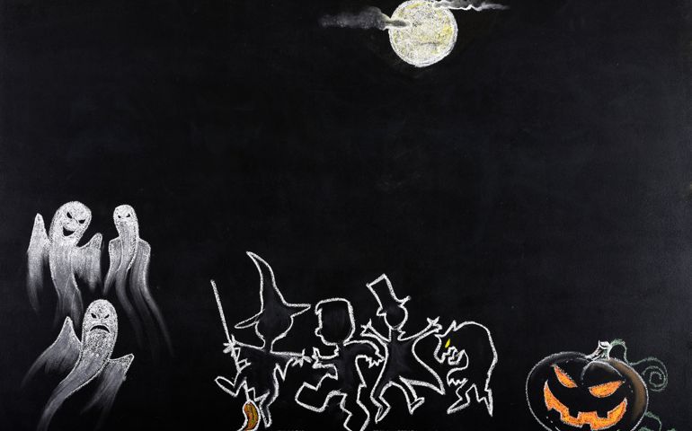 Halloween party sketched on blackboard.