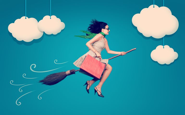 Happy woman on the broom is flying in the sky after shopping.