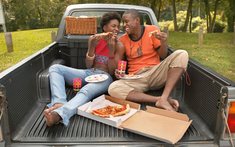 Couple Eating Pizza in Pickup Bed