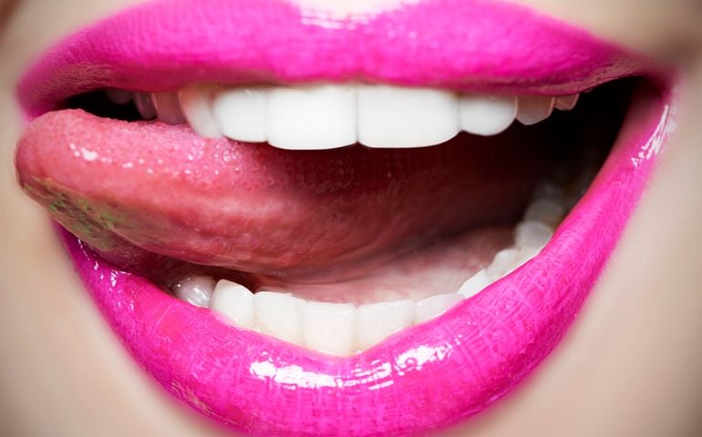 Tongue licking pink lips