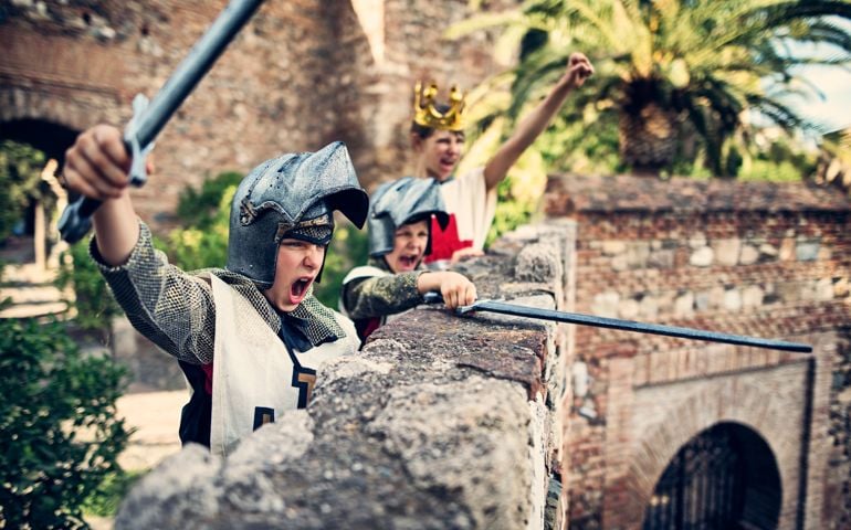 Little knights and the young queen cheering on the castle walls. Theay have defended the castle from the assault.