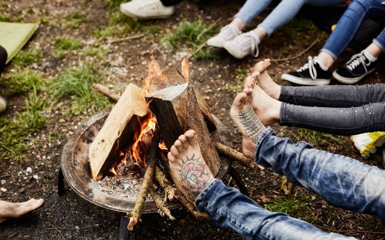 Legs around camp fire