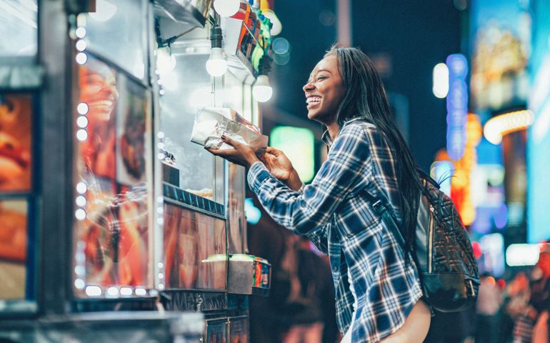 Africa American Woman at a Hot Dog Stand in Times Square, New York City.