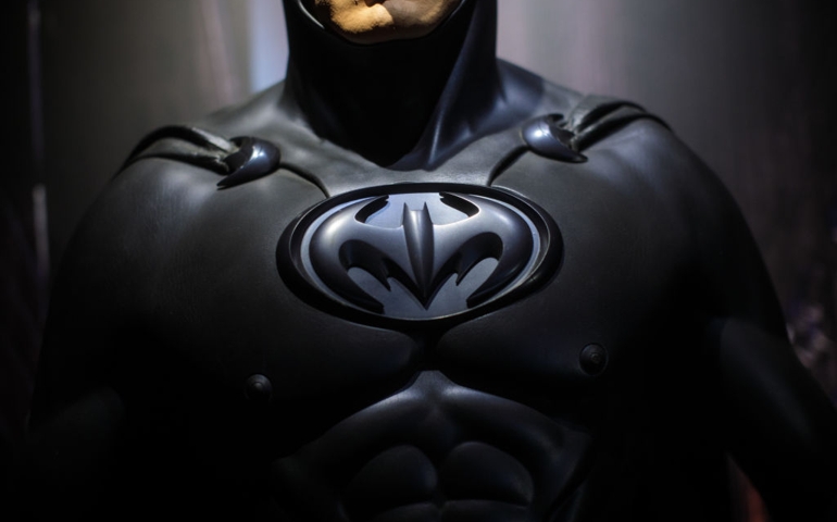 LONDON, ENGLAND - FEBRUARY 22: A Batman costume from the 1997 Batman &amp; Robin film worn by George Clooney and designed by Rob Ringwood and Mary Vogt is on display at the DC Comics Exhibition: Dawn Of Super Heroes at the O2 Arena on February 22, 2018 in London, England. The exhibition, which opens on February 23rd, features 45 original costumes, models and props used in DC Comics productions including the Batman, Wonder Woman and Superman films.