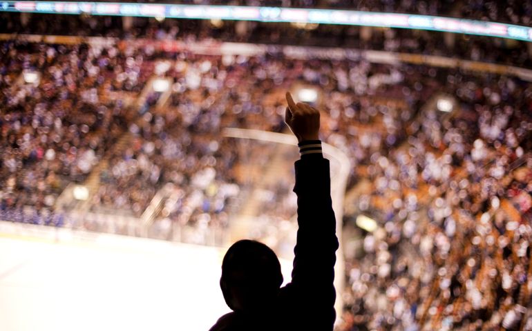 Sports fan cheering at hockey game