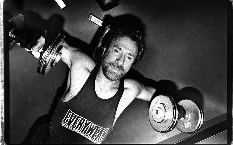 NEW YORK - APRIL 1993: American martial artist and actor Chuck Norris exercises by lifting weights on April 1993 in New York City, New York.