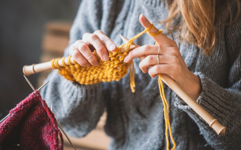 Close up on woman's hands knitting