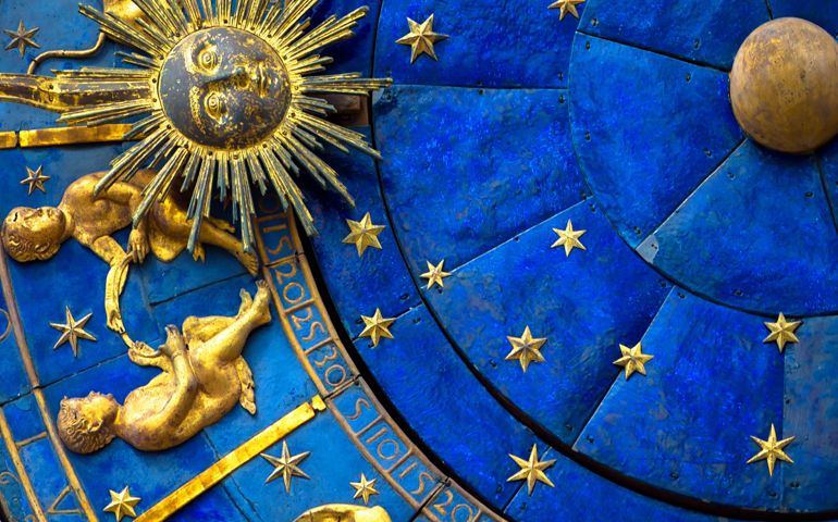 Gemini astrological sign on ancient clock, medieval Torre dell’Orologio in Venice. Detail of Zodiac wheel with Sun and Twins. Golden symbol of Gemini on star circle closeup. Concept of astrology and horoscope.