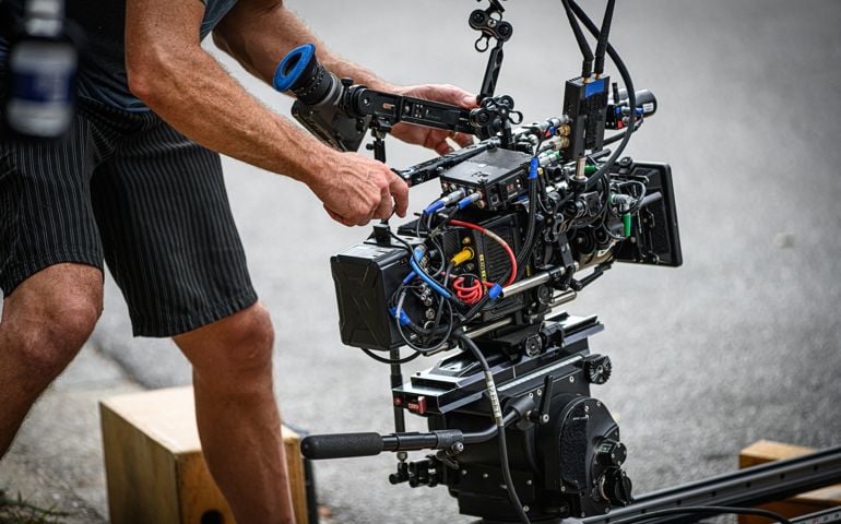 A digital cinema camera on a fluid head and a 3ft. camera slider.